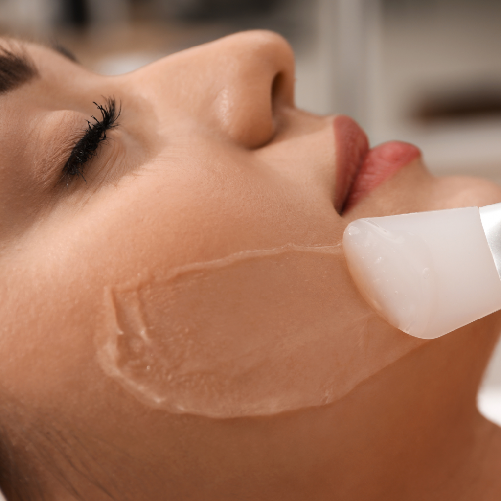 Chemical Peel - RiKo Aesthetics Woman having chemical peel solution applied to face